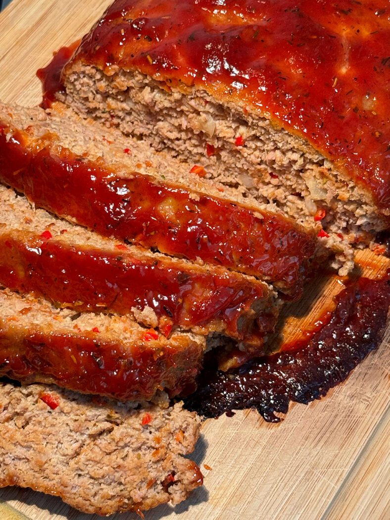 Meatloaf sliced on a cutting board 